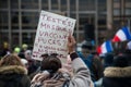 People protesting against the sanitary pass with text in french : testes, masques, vaccines puces, in english : tested, masked, va