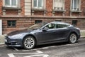 Profile view of grey Tesla car parked in the street, tesla is the fmous american brand of electric cars