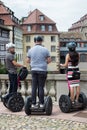 Portrait of tourists riding gyropodes in the street