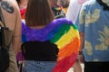 Young woman wearing a rainbow angel wings during the gay pride