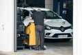 Servicemen repairman working at the diagnostic center next to a new white Royalty Free Stock Photo