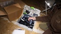 Worker male unboxing new systainer Festool Rotex sanding machine