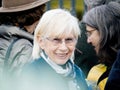 A smiling woman looking at the camera in fornt of Court for Human Rights,