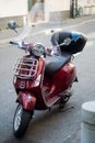 Front view of red vespa scooter parked in the street Royalty Free Stock Photo