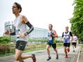 Focused men running marathon