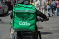 Portrait of uber eats delivery man in bicycle waiting in the street