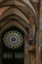 Rosette stained glass window by the interior of famous Notre Dame Cathedral de Strasbourg, France