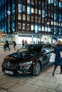 Shopper passing by luxury black Renault Talisman Royalty Free Stock Photo