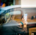 Woman holding latest iPhone X inside Apple Store