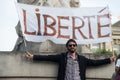 man protesting in the street against the sanitary pass with banner and text in french : liberte, traduction in english : freedom Royalty Free Stock Photo