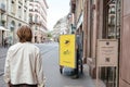 Rear view of postal worker searching for letter parcel in his electric bike Royalty Free Stock Photo