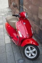 Front view of red vespa scooter parked in the street Royalty Free Stock Photo