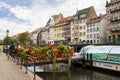 Strasbourg's cityscape with a sight-seeing boat on Ill river