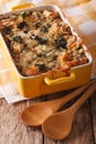 Strata casserole with spinach, cheese and bread close up. vertical
