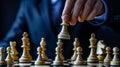 Strategic businessman in suit moving chess figure on chessboard