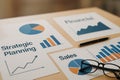 Strategic Planning Documents With Graphs and Charts on a Wooden Table Royalty Free Stock Photo