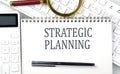 STRATEGIC PLANNING . Text on notepad with calculator and keyboard,business concept Royalty Free Stock Photo