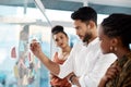 Strategising at its best. a diverse group of businesspeople standing and using a glass board with post-its in the office Royalty Free Stock Photo