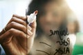 The strategist is at it again. Closeup shot of a young businesswoman writing notes on a glass screen in an office. Royalty Free Stock Photo