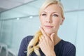 Strategizing for career success. Closeup of an attractive young blonde woman standing in an office and thinking about Royalty Free Stock Photo
