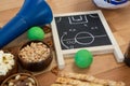 Strategy board, snacks and balls on wooden table