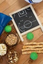 Strategy board, snacks and balls on wooden table