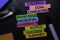 Strategy, Goal, Consulting, Knowledge, Potential, Experience, Advice, Success, Support text on sticky notes isolated on Black desk Royalty Free Stock Photo