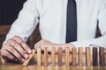 Strategy and successful intervention concept for business, businessman hand Stopping Falling wooden Dominoes effect from Royalty Free Stock Photo