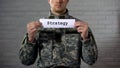 Strategy Word Written On Sign In Hands Of Male Soldier, Battle Plan, Defense