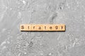 STRATEGY word written on wood block. STRATEGY text on cement table for your desing, concept Royalty Free Stock Photo