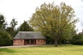 Public Toilet Block at Old Town, with tree and grass. Stratford-upon-Avon, UK. April 27, 2023.