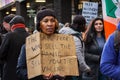 STRATFORD, LONDON, ENGLAND- 5 December 2020: Anti-lockdown Standupx protester carrying a sign in Stratford