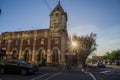 Strathcona Public Building - an old brick house with a tower and clock. Old post office. Amazing sunset, sun rays, clear sky.