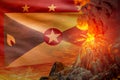 stratovolcano blast eruption at night with explosion on Grenada flag background, problems of eruption and volcanic earthquake Royalty Free Stock Photo