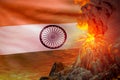 stratovolcano eruption at night with explosion on India flag background, suffer from eruption and volcanic earthquake conceptual