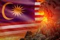 stratovolcano eruption at night with explosion on Malaysia flag background, problems of natural disaster and volcanic earthquake