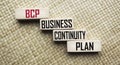 On a straw background, wooden blocks with the text BCP Business Continuity Plan Royalty Free Stock Photo