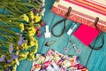 straw bag, dress, colorful flowers, cosmetics makeup, notepad, bijou and essentials on blue wooden background Royalty Free Stock Photo