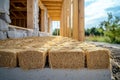 Straw bale insulation creating an eco-friendly and energy-efficient floor within a wooden frame house under construction Royalty Free Stock Photo