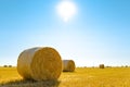 Straw Bales on the Bright Yellow Field under Blue Sky. Royalty Free Stock Photo