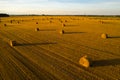 Straw bales on farmland with a blue cloudy sky.Harvested field with bales in Europe.Harvest.Belarus Royalty Free Stock Photo