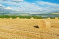 Straw bales on field after harvest and blue sky Royalty Free Stock Photo