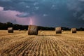 Straw bales in the field after harvest with thunderstorm. Royalty Free Stock Photo