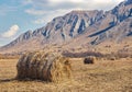 Straw bales on the field and mountain ridges Royalty Free Stock Photo