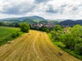 Straw bales on the field near Saschiz fortified church in Saschiz villages, Sibiu, Transylvania, Romania. Agriculture landscape, g Royalty Free Stock Photo