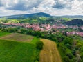 Straw bales on the field near Saschiz fortified church in Saschiz villages, Sibiu, Transylvania, Romania. Agriculture landscape, g Royalty Free Stock Photo