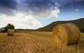 Straw-bales field with stormy sky Royalty Free Stock Photo