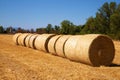 Straw bales on the field under blue sky with white clouds Royalty Free Stock Photo