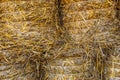 Straw bales stacked background. Harvested field with bales, wheat harvesting for bread production Royalty Free Stock Photo
