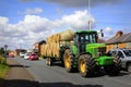 Straw bales tractor on countryside road UK